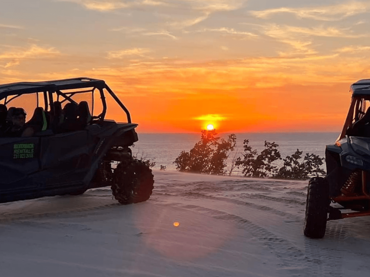 a truck with a sunset in the background